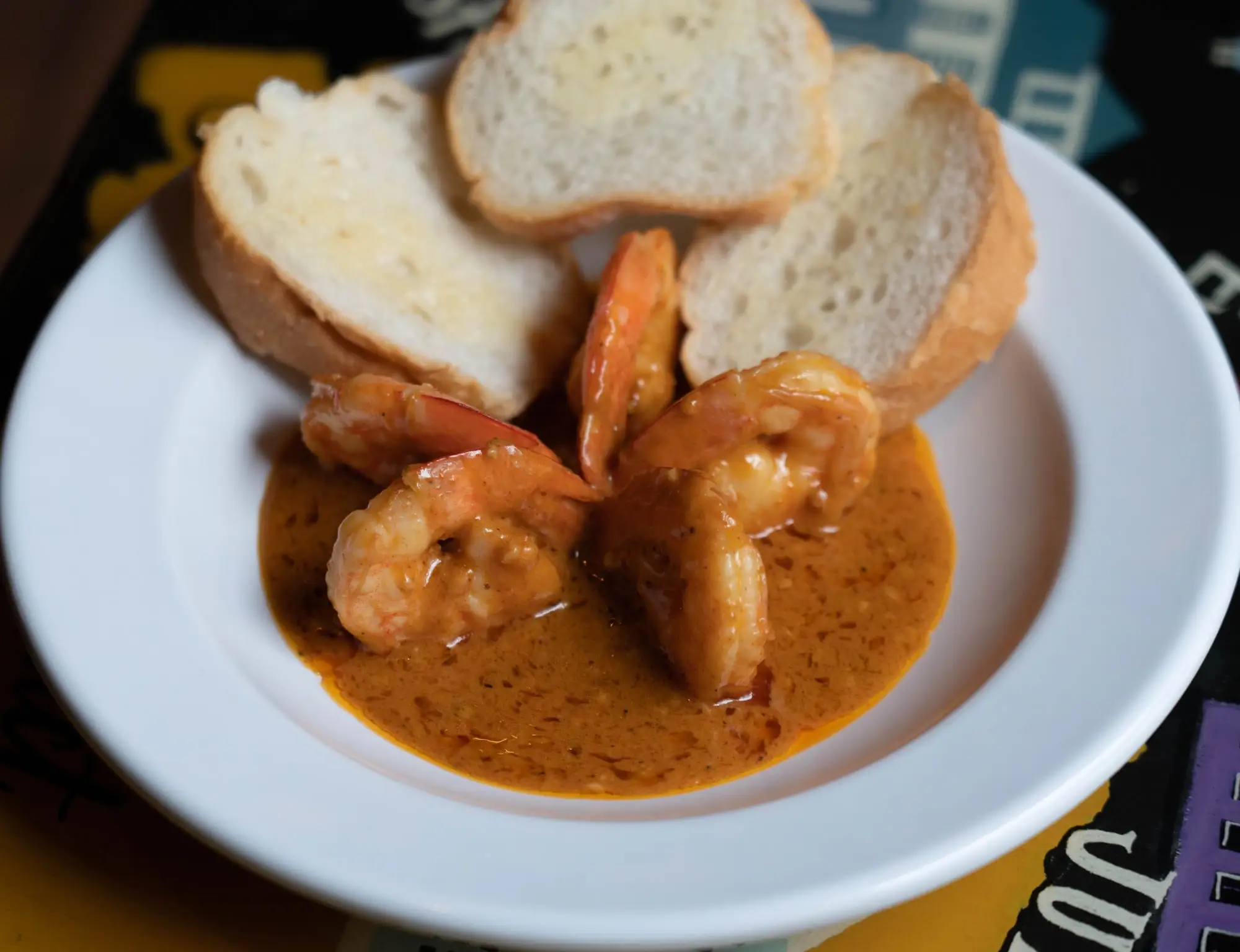 New Orleans barbecued shrimp in a peppery butter sauce with toasted French bread