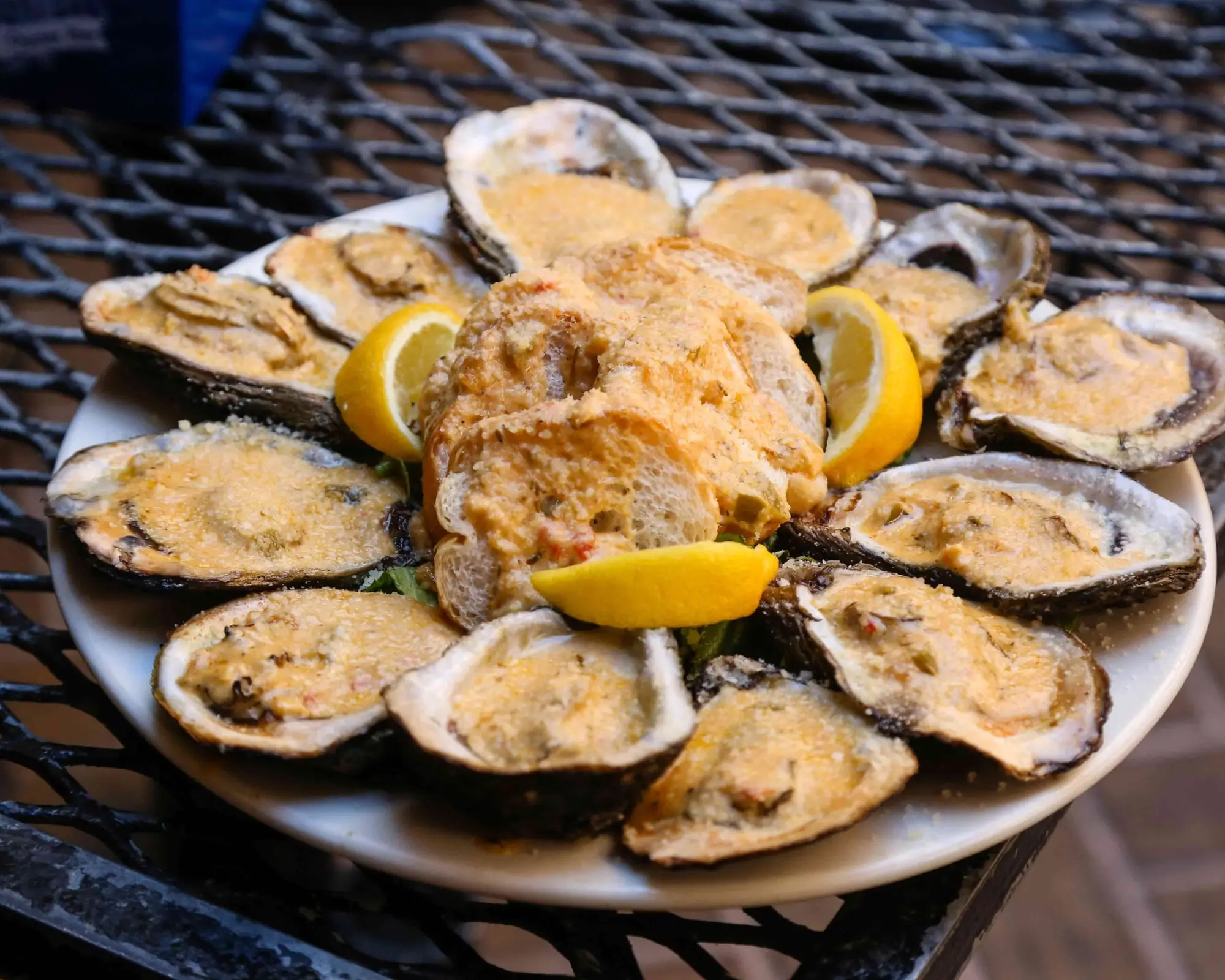 A platter of chargrilled oysters with parmesan, garlic butter and lemon