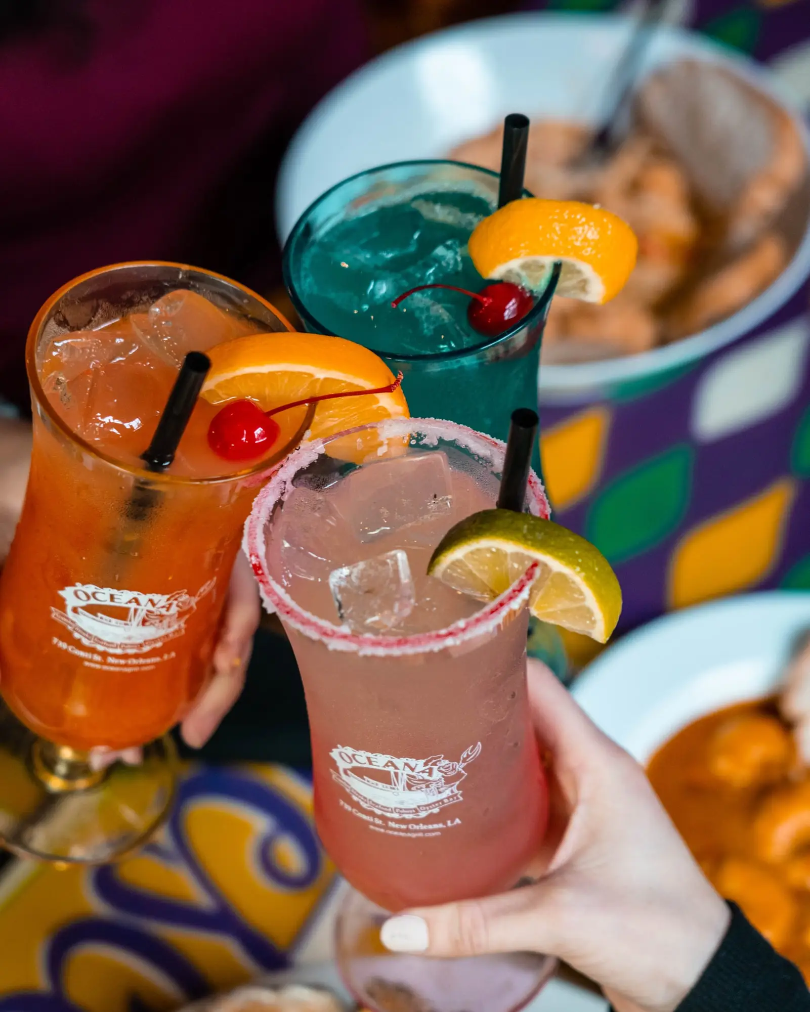 Two guests clinking Oceana cocktails in branded glasses