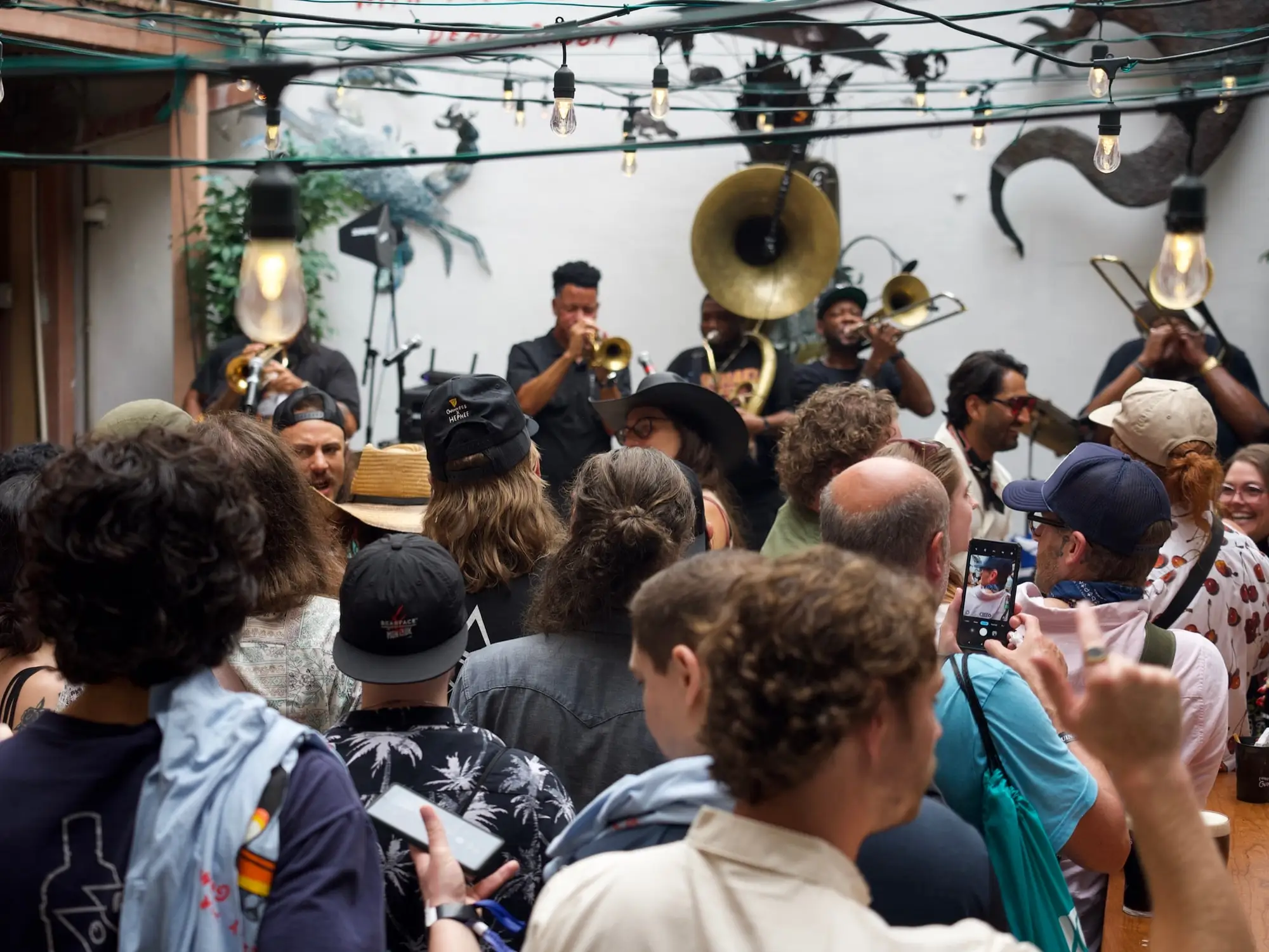 A brass band playing to a packed crowd in Oceana Grill’s courtyard during a private event