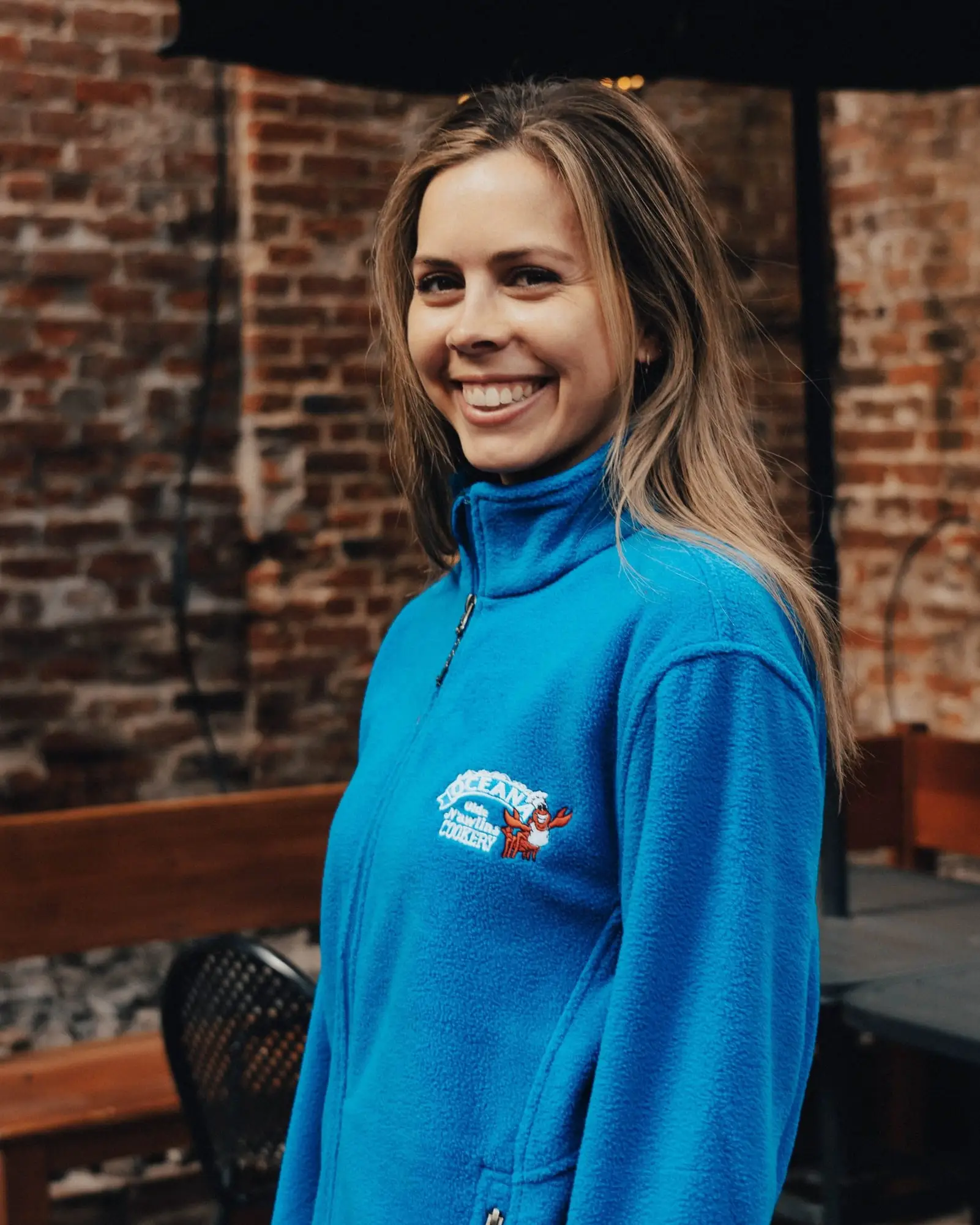 A woman wearing the blue Oceana fleece