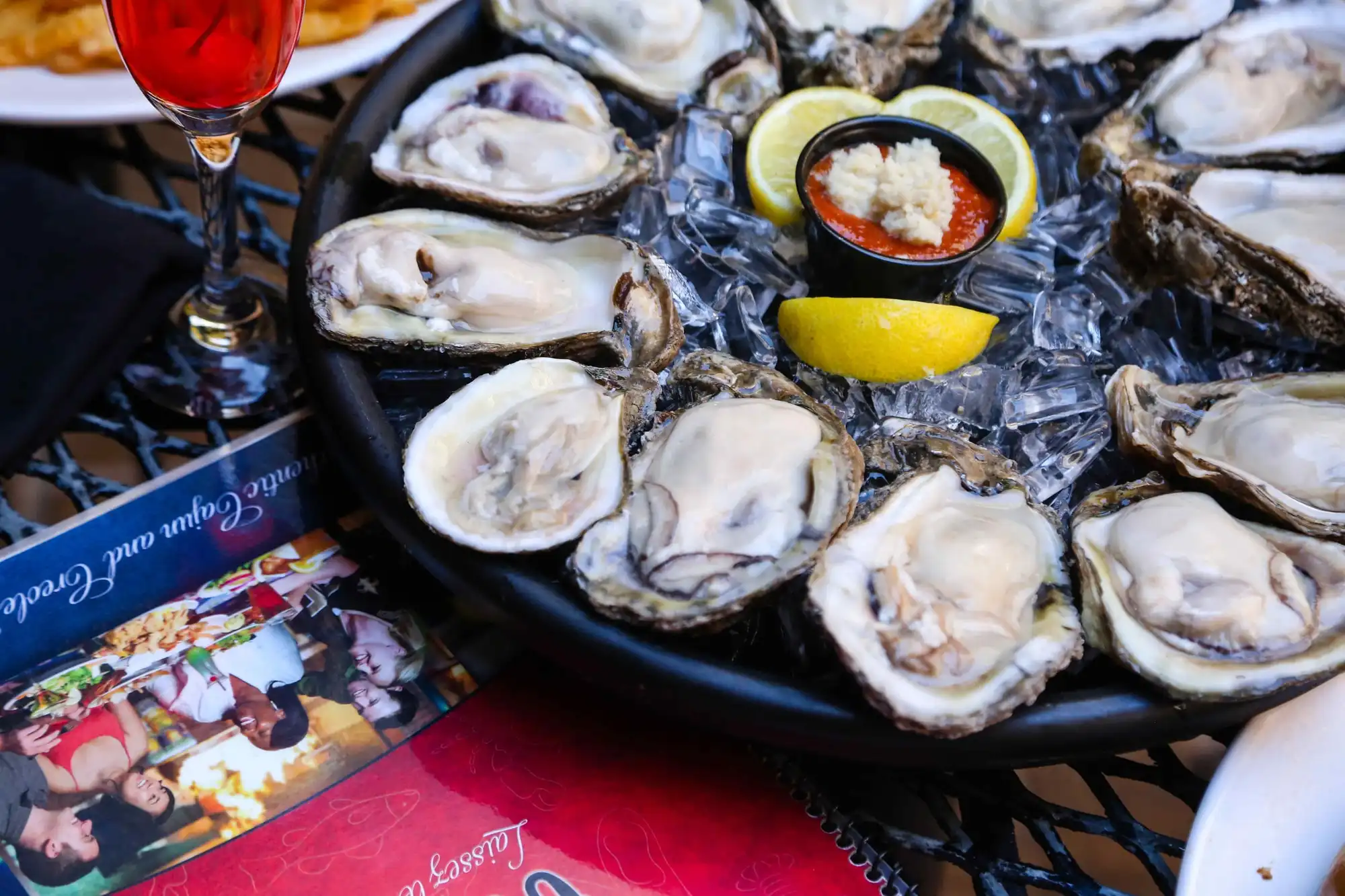Freshly shucked Louisiana oysters on the half shell over ice with lemon and cocktail sauce